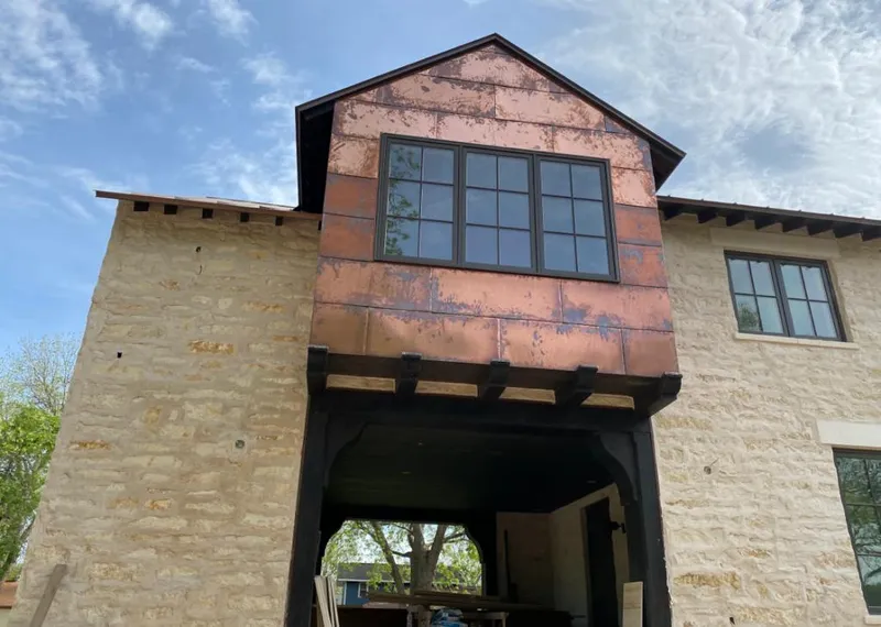 Copper metal panel facade on a stone building for Metal Roof Coating in Old Jamestown